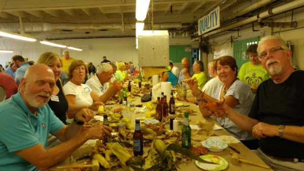 Crab Picking in Cambridge at the J.M. Clayton Co cannery. on right, John and Madi Yates, hosts, Cheryl Goldberg, and further down, Molly and Wally Stone; on left, Bill and Laurie Crosley, Vern and Dorothy Penner, and further down, Candy and Ben Wilson.