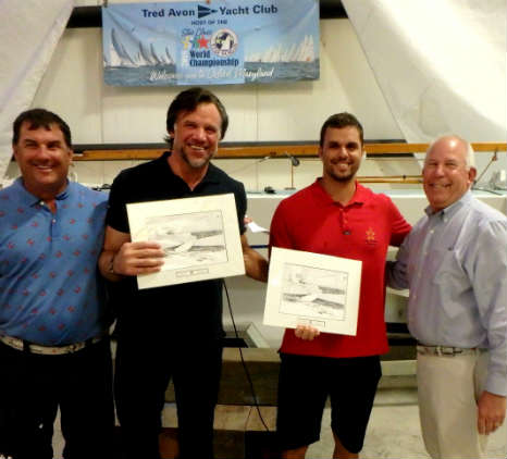 2018 Star World Champions Guilherme de Almeida and Jorge Zarif (red shirt) collect one of several daily awards at the casual crab feast on Thursday. These are custom pen and ink drawings by Marc Castelli. Photo by SpinSheet