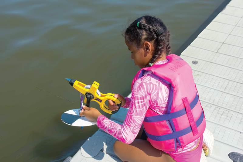 Learning about turbidity young girl with instrument learning about water turbidity
