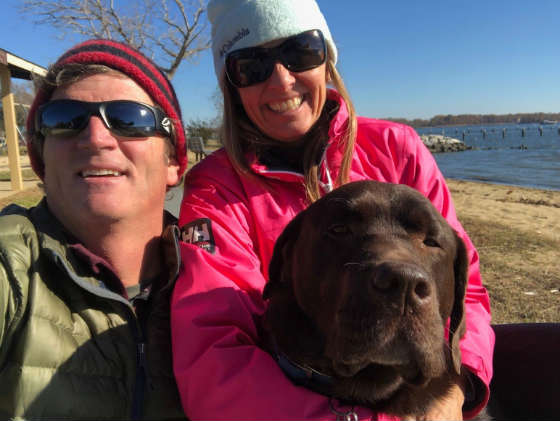 Geoff and Mary Ewenson, holding tight to Angus so that he poses instead of diving in 