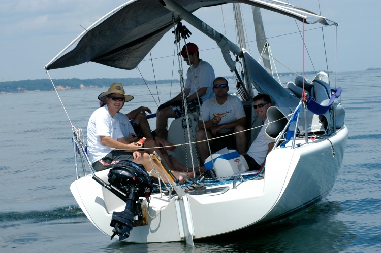 Dave Prucnal's Ultra Violet team knows how to cool off at the Screwpile Regatta, with a good boom tent and sliced watermelon! Photo by SpinSheet