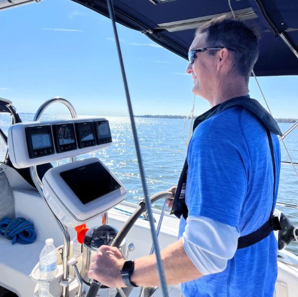 A man sailing a sailboat