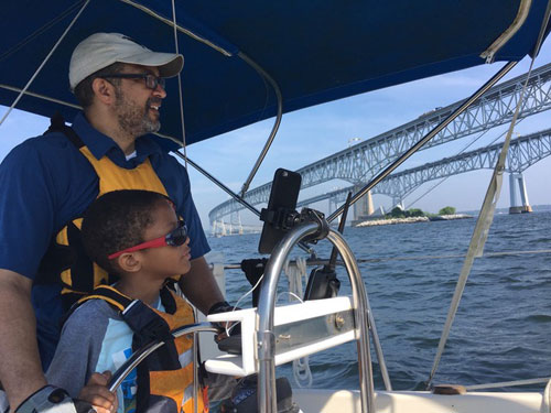 On the Cogburn's second boat, their son has his own cabin. Here he takes a turn at the helm.