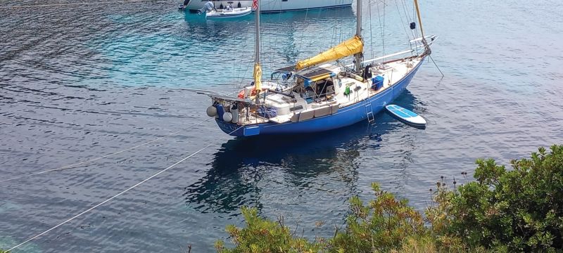 a sailboat anchored in Greece