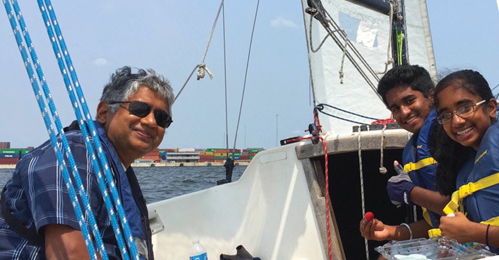 Harish Neelakandan sailing with his kids Man sailing with his children