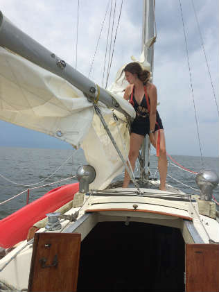 Taking the mainsail down before the storm. Photo by Shannon Hibberd