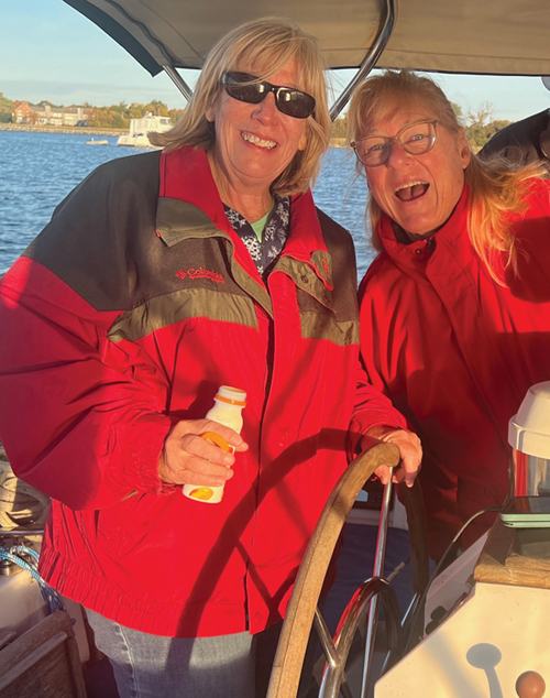 Singles on Sailboats sailors two Singles on Sailboats sailors smiling on a sailboat