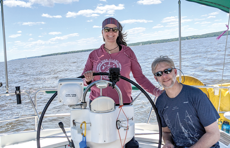 Liz at helm with Doug sailing