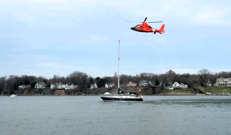 Aerial Rescue Demonstration during Safety At Sea 2025 at the US Naval Academy Aerial rescue demonstration, Coast Guard helicopter hovers over sailboat