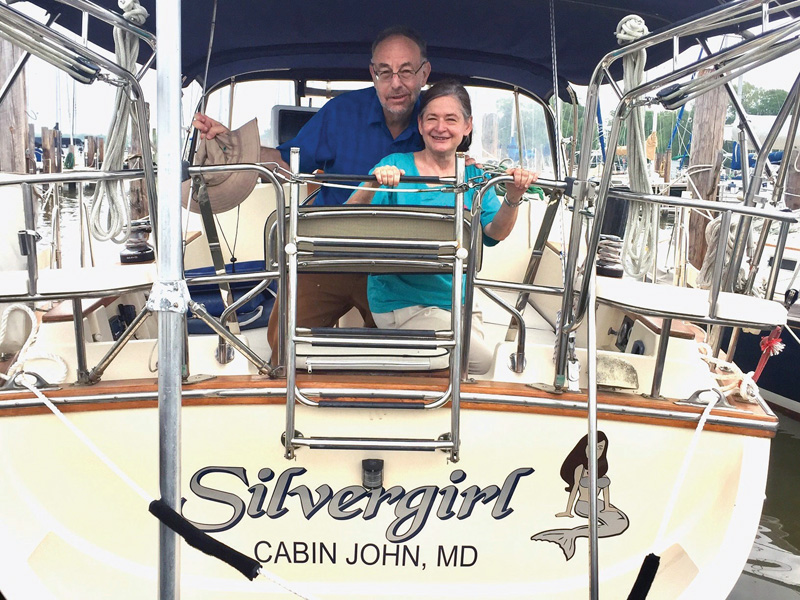 Mike and Gail Marcus at the stern of their sailboat Mike and Gail Marcus at the stern of their sailboat