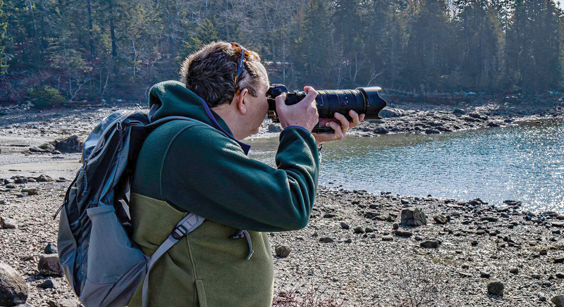 Photographer looking through his camera