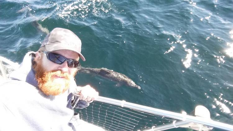 Sean sees a dolphin from aboard his boat