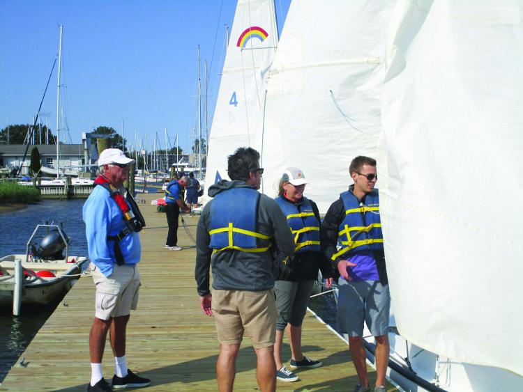 An instructor and students on the new floating docks at Annapolis Sailing School. 