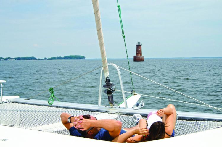 Relaxing on a chartered catamaran sailing yacht at Bloody Point