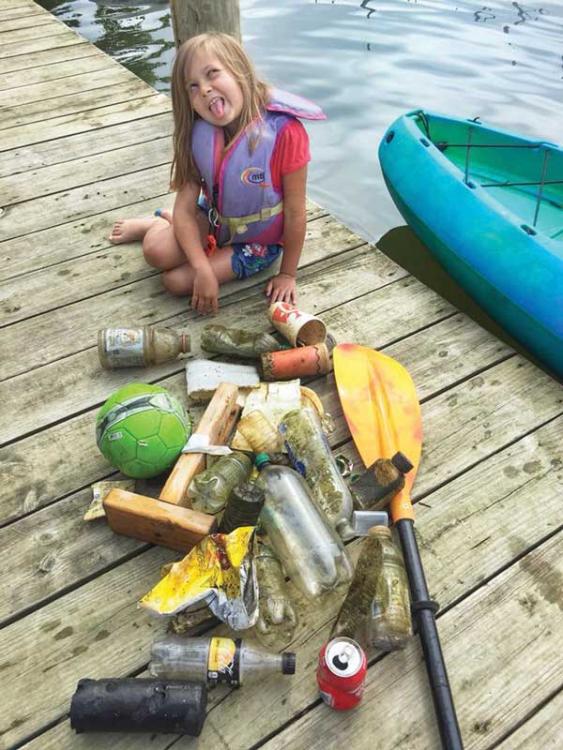 Cindy Wallach trash cleanup with her daughter aboard their kayak