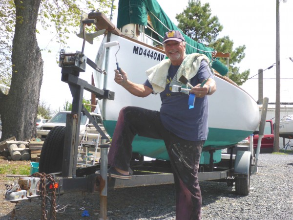 Mystic Wind, a 20-foot catboat, with her proud owner