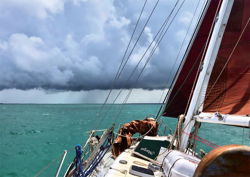 sailboat cruising toward the horizon