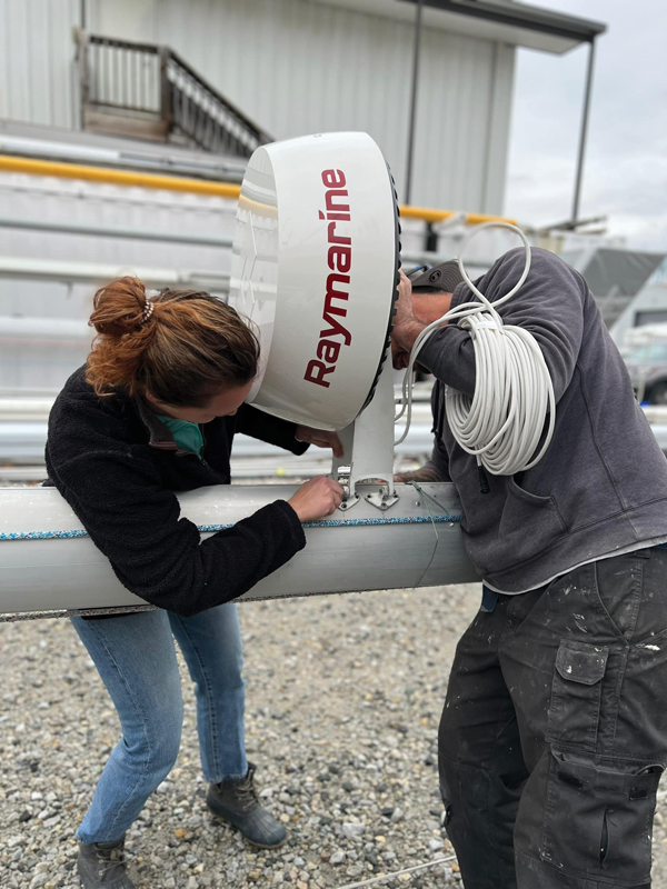 inspecting a sailboat mast