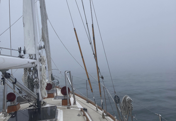 Navigating through fog in Maine Cruising sailboat underway in foggy conditions