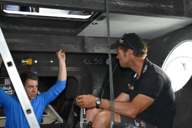 Down below on the 110-foot tri Sodebo Ultim, Brady from Helly Hansen asks Coville about life onboard. Photo by SpinSheet