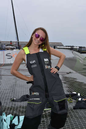 Elana tries on Coville's Helly Hansen bibs onboard Sodebo Ultim. Photo by SpinSheet