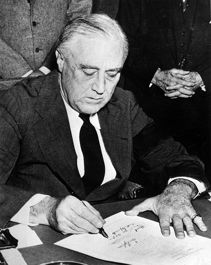 Franklin Roosevelt signing the declaration of war against Japan.