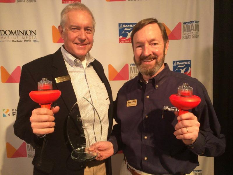 Peter Trogdon (left) with Drew Fleming, both holding the SOS Distress Light. Courtesy Weems and Plath/Facebook