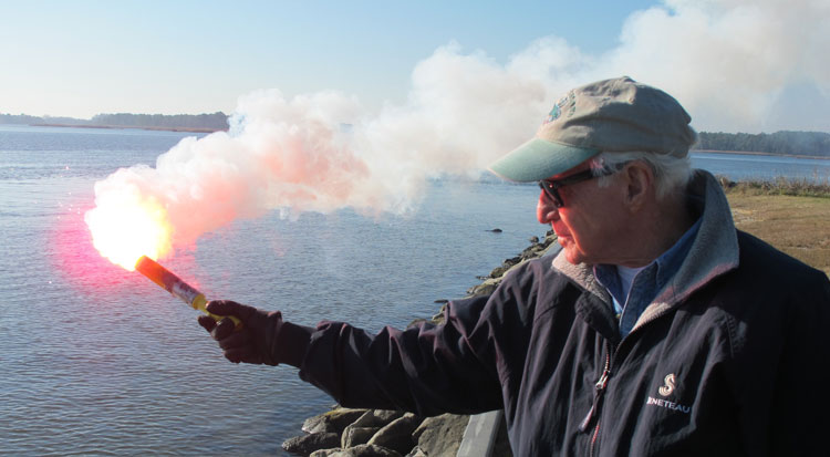 Sam Lyness with the Annapolis Sail and Power Squadron practices shooting flares. Photo by Terry Slattery                         