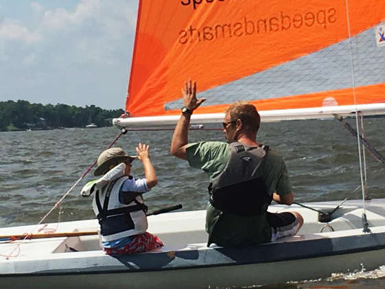 One design racing on small boats is for all age groups... high five! Photo by Dan Phelps/ SpinSheet
