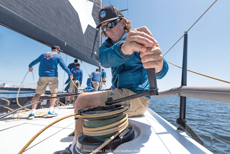 Data informs communications and decision making when racing sailboats man grinding the winch on a racing sailboat