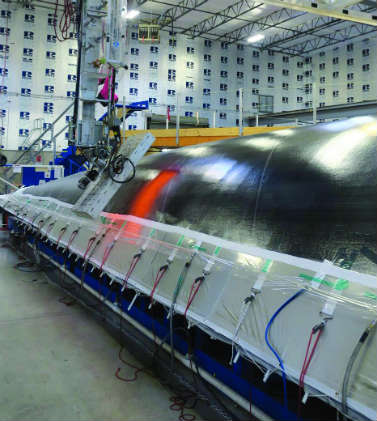 A giant heater moving along the sail is part of the process to form unitary sail membrane.