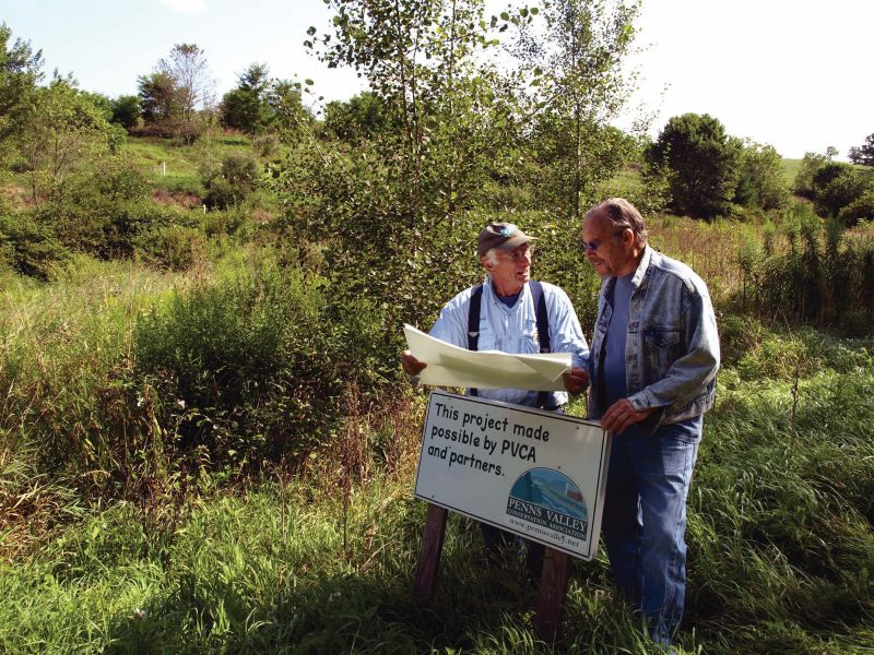 two men in a natural area outdoors