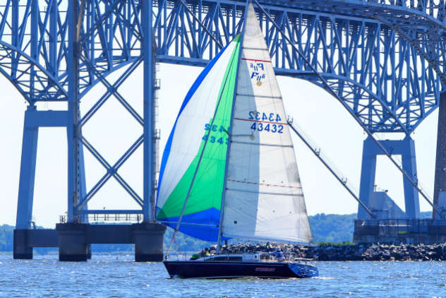 A CHESSS sailor managing their spinnaker. Photo by Jim Little.