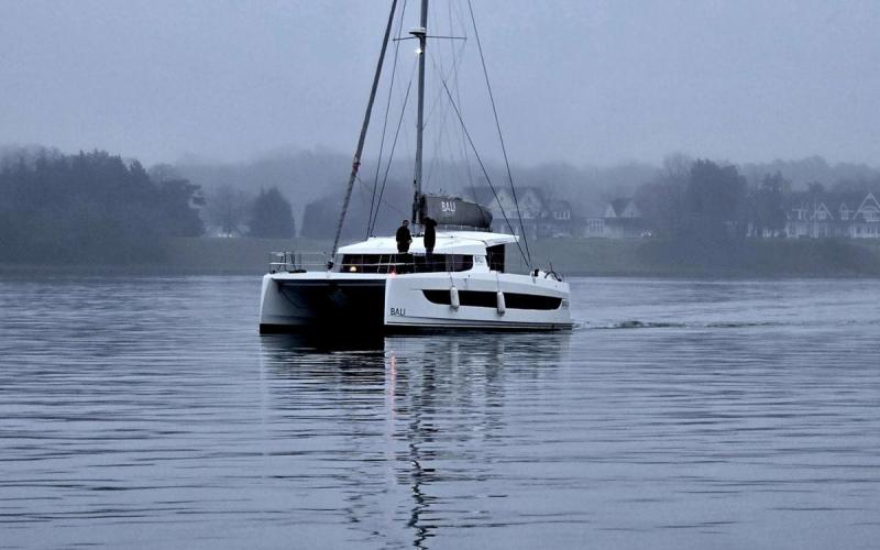 A catamaran heading up South River with attentive crew watching out in the foggy conditions....