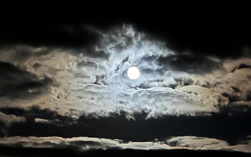 Blue moon emerging from the clouds