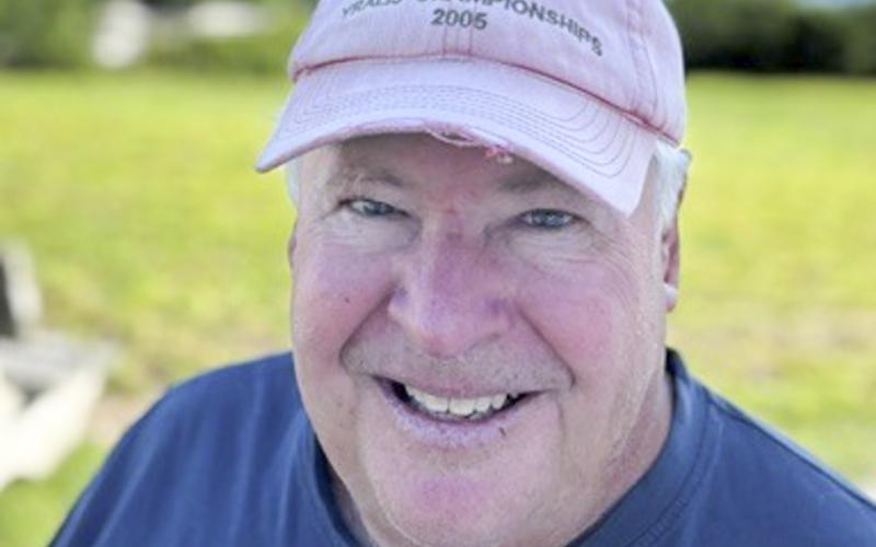 Al Lawrence honors his friend with his well-traveled 2005 cap.