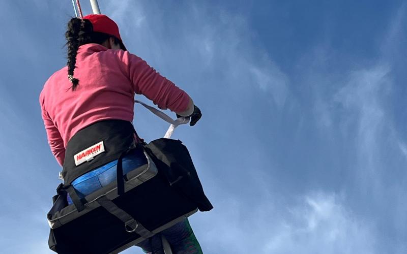 Hannah Garbee goes aloft in her red cap.