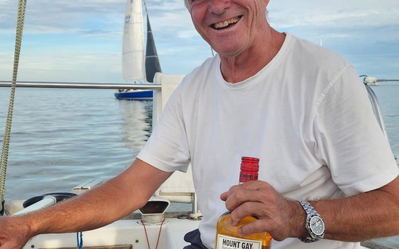 Heidi Frist's shot of of Tapio Lehtinen, holding a Mt Gay bottle at the helm of Suzie Q