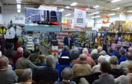 Tucker Thompson speaks in front of a crowd at Fawcett Boat Supplies in Annapolis. Photo by Craig Ligibel