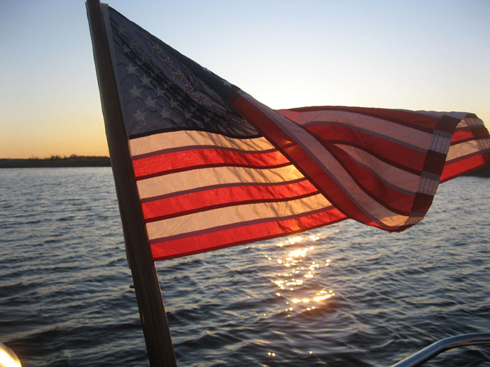 Sunset behind the flagstaff on the last sailing trip of the season. Photo by Steve Allan.