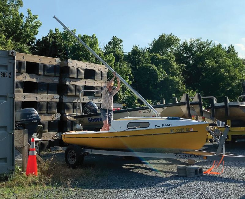 The author steping the mast of his sailboat stepping the mast of a sailboat